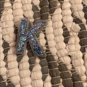 Blue K sparkly pin